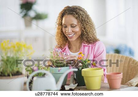 Picture - Woman potting flowers. Fotosearch