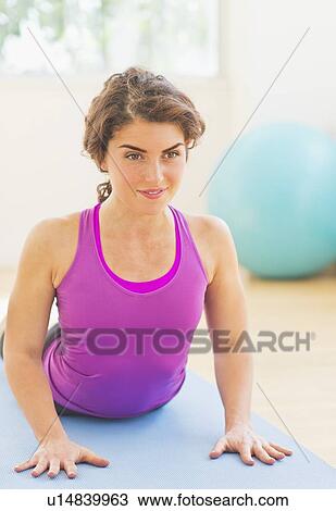 Stock Image - Woman practicing yoga. Fotosearch