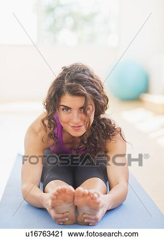 Stock Image - Woman practicing yoga. Fotosearch