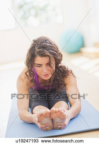 Stock Image - Woman practicing yoga. Fotosearch
