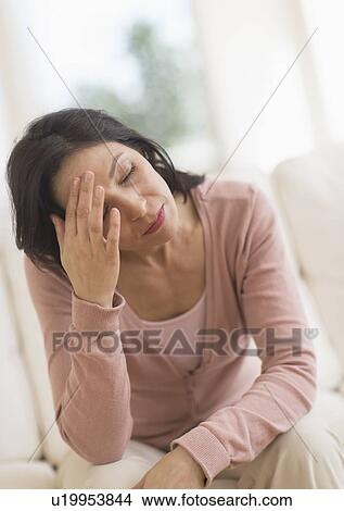 Woman sitting with head in hands View Large Photo Image Picture - Woman sitting with head in hands. Fotosearch