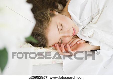Woman sleeping in bed View Large Photo Image Stock Photo - Woman sleeping in bed. Fotosearch