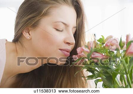 Woman smelling flowers View Large Photo Image Stock Image - Woman smelling flowers. Fotosearch