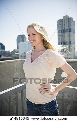 Woman standing on balcony View Large Photo Image Stock Photography - Woman standing on balcony. Fotosearch