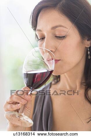 Picture - Woman tasting red wine. Fotosearch