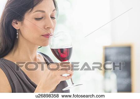 Stock Photo - Woman tasting red wine. Fotosearch