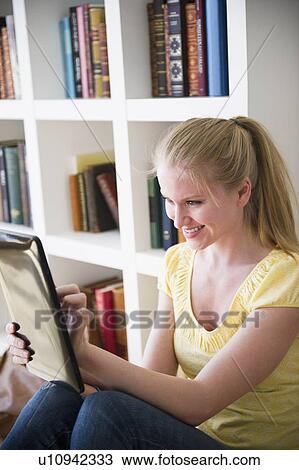Woman using digital tablet View Large Photo Image Stock Image - Woman using digital tablet. Fotosearch