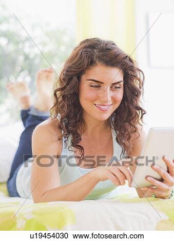 Woman using digital tablet View Large Photo Image Stock Image - Woman using digital tablet. Fotosearch