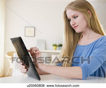 Woman using digital tablet View Large Photo Image Stock Photo - Woman using digital tablet. Fotosearch