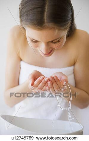 Woman washing face View Large Photo Image Stock Photo - Woman washing face. Fotosearch