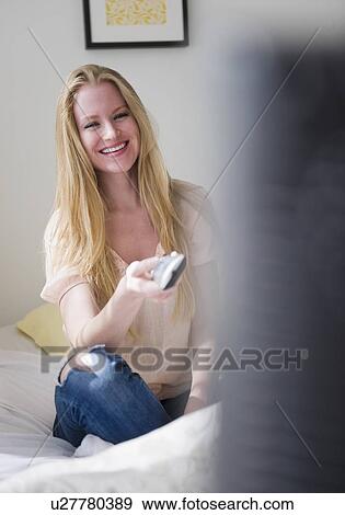 Woman watching tv View Large Photo Image Stock Photo - Woman watching tv. Fotosearch