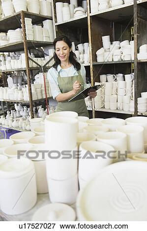 Woman with checklist in pottery warehouse View Large Photo Image Stock Photo - Woman with checklist in pottery warehouse. Fotosearch