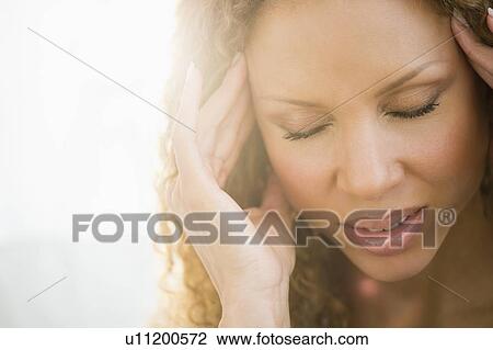 Stock Image - Woman with headache. Fotosearch