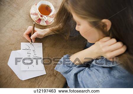 Stock Image - Woman writing greeting card. Fotosearch
