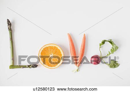 Stock Image - Word 'love' made out of fruits and vegetables, studio shot. Fotosearch