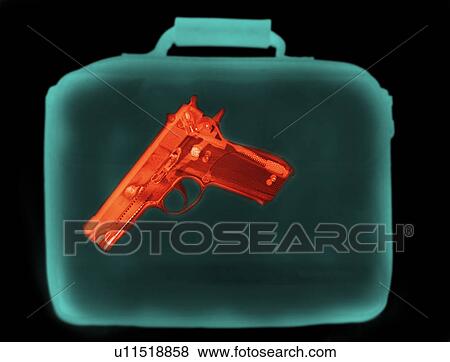 Stock Photo - X-ray image showing handbag containing pistol. Fotosearch