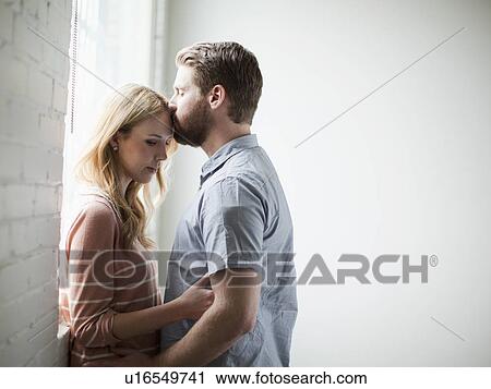 Stock Image - Young couple kissing. Fotosearch