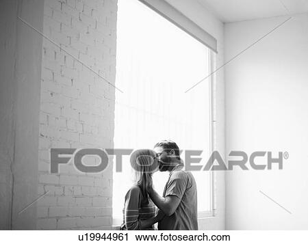 Young couple kissing View Large Photo Image Stock Image - Young couple kissing. Fotosearch