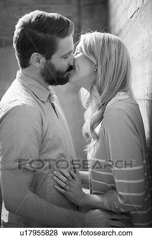 Stock Photo - Young couple kissing. Fotosearch