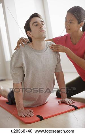 Stock Image - Young couple training together. Fotosearch