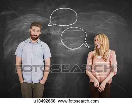 Young couple with speech bubble on blackboard, studio shot View Large Photo Image Stock Photo - Young couple with speech bubble on blackboard, studio shot. Fotosearch