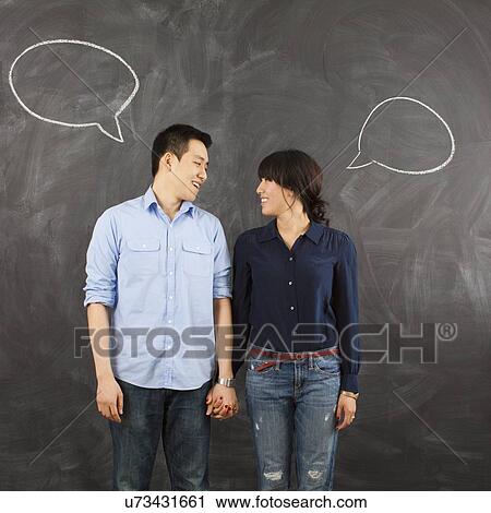 Young couple with speech bubbles on chalkboard, studio shot View Large Photo Image Stock Image - Young couple with speech bubbles on chalkboard, studio shot. Fotosearch