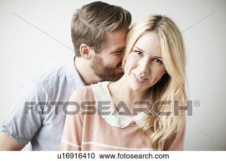 Stock Image - Young happy couple, studio shot. Fotosearch