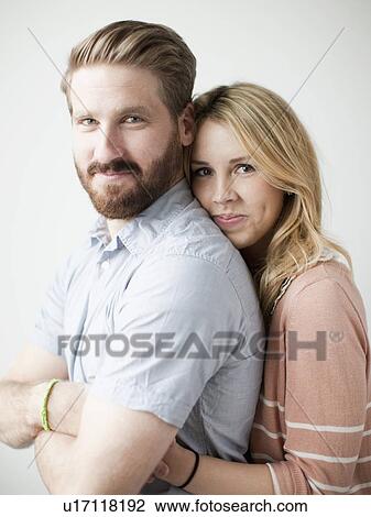 Young happy couple, studio shot View Large Photo Image Stock Image - Young happy couple, studio shot. Fotosearch