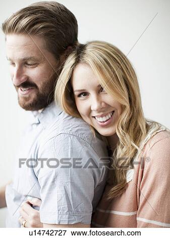 Stock Photo - Young happy couple, studio shot. Fotosearch