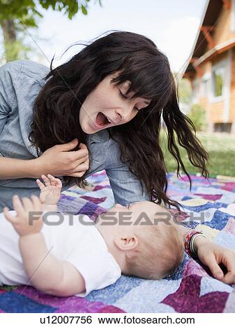 Young mother embracing baby boy (6-11 months) View Large Photo Image Stock Photograph - Young mother embracing baby boy (6-11 months) . Fotosearch
