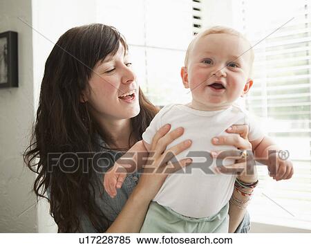 Young mother embracing baby boy (6-11 months) View Large Photo Image Stock Photography - Young mother embracing baby boy (6-11 months) . Fotosearch