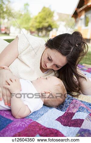 Stock Image - Young mother embracing toddler boy ( 2-3). Fotosearch