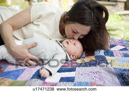 Young mother kissing baby boy ( 2-5 months) View Large Photo Image Stock Photo - Young mother kissing baby boy ( 2-5 months). Fotosearch
