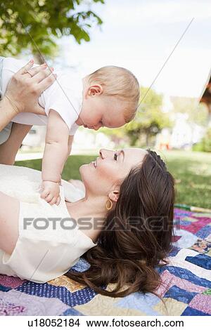Picture - Young mother kissing toddler boy ( 2-3). Fotosearch