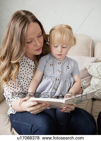 Young mother reading to toddler girl (2-3) View Large Photo Image Stock Photo - Young mother reading to toddler girl (2-3). Fotosearch