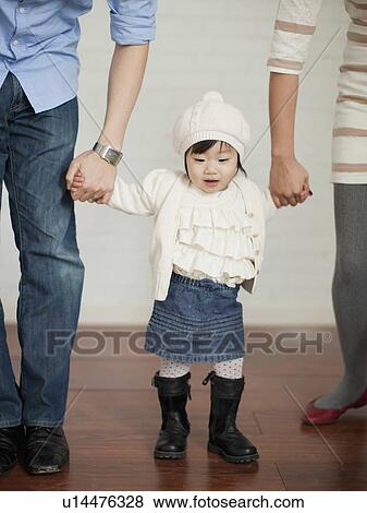 Young parents with baby girl (12-17 months) View Large Photo Image Stock Photo - Young parents with baby girl (12-17 months). Fotosearch