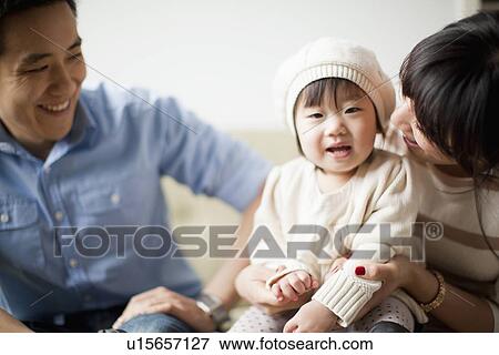 Young parents with baby girl (12-17 months) View Large Photo Image Stock Photo - Young parents with baby girl (12-17 months). Fotosearch