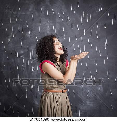 Young teacher posing against blackboard with V marks imitating rain View Large Photo Image Stock Image - Young teacher posing against blackboard with V marks imitating rain. Fotosearch