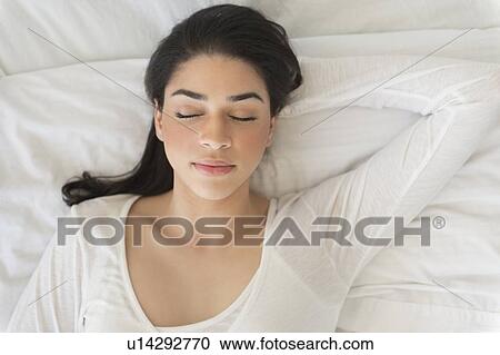 Young woman asleep in bed View Large Photo Image Stock Image - Young woman asleep in bed. Fotosearch