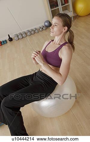 Young woman exercising View Large Photo Image Picture - Young woman exercising. Fotosearch