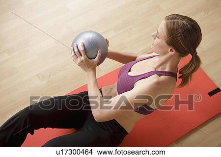 Young woman exercising View Large Photo Image Picture - Young woman exercising. Fotosearch