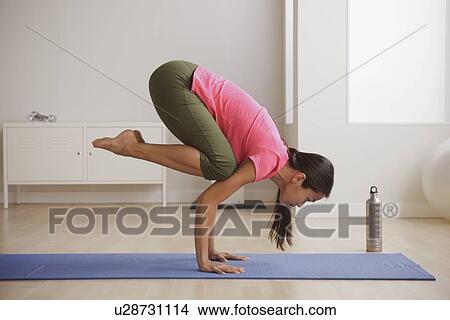 Picture - Young woman exercising. Fotosearch