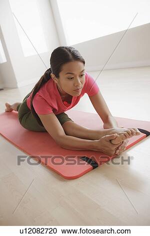 Young woman exercising View Large Photo Image Stock Image - Young woman exercising. Fotosearch