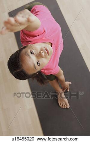 Stock Image - Young woman exercising. Fotosearch