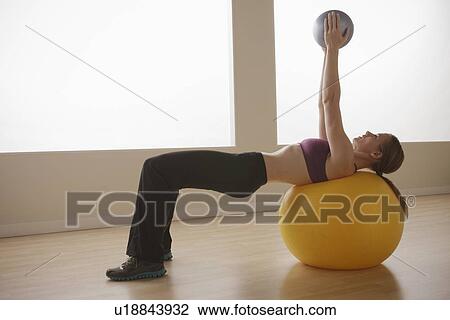Young woman exercising View Large Photo Image Stock Image - Young woman exercising. Fotosearch