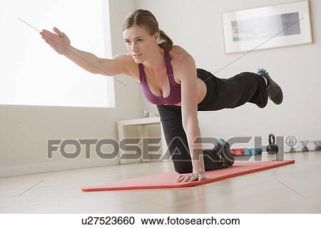 Young woman exercising View Large Photo Image Stock Image - Young woman exercising. Fotosearch