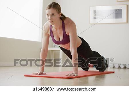 Young woman exercising View Large Photo Image Stock Photo - Young woman exercising. Fotosearch