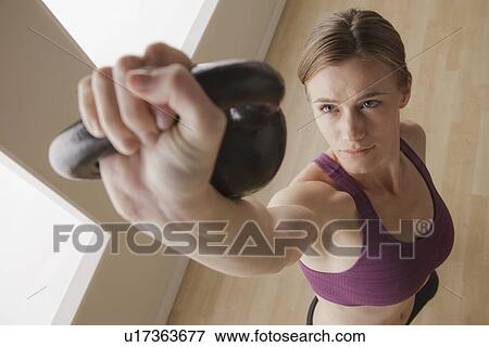 Young woman exercising View Large Photo Image Stock Photo - Young woman exercising. Fotosearch