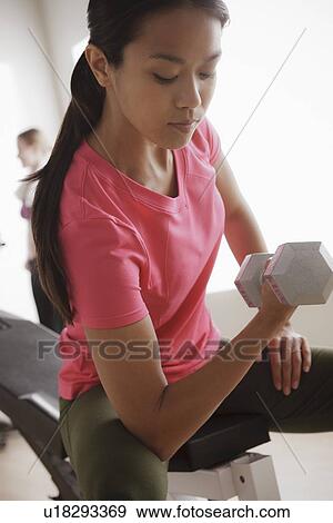 Young woman exercising View Large Photo Image Stock Photo - Young woman exercising. Fotosearch