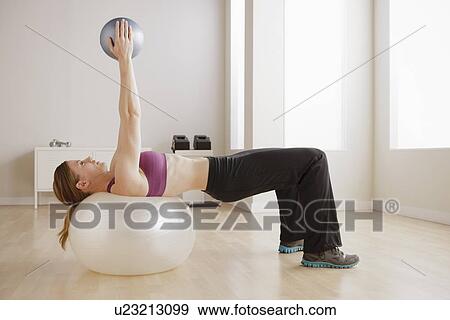 Young woman exercising View Large Photo Image Stock Photo - Young woman exercising. Fotosearch